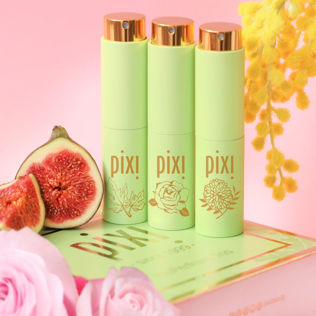 PixiPerfume Gift Trio shown on a pink background with plants